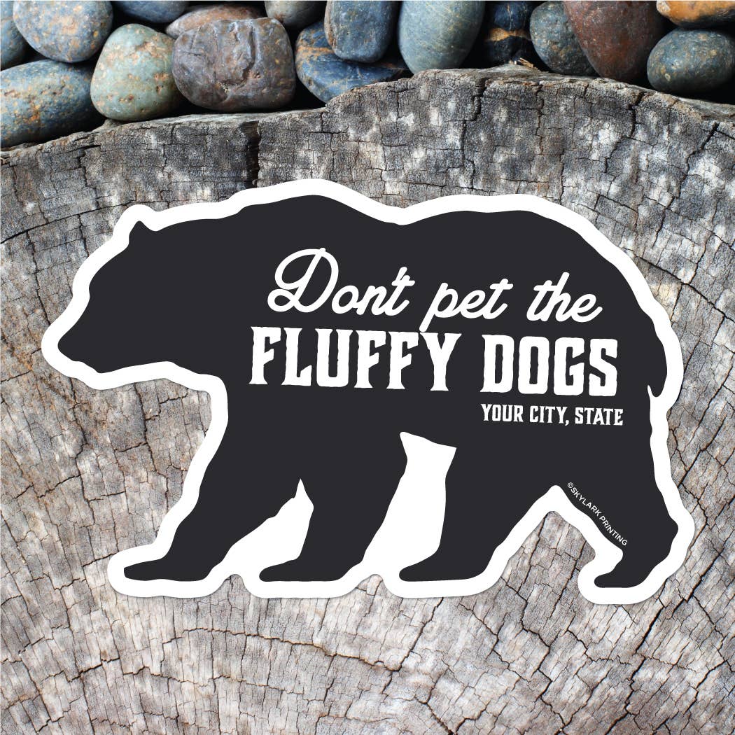 Black bear silhouette sticker with text on a wooden surface