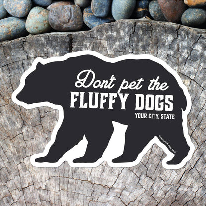 Black bear silhouette sticker with text on a wooden surface