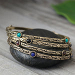 Decorated Brass Bangle Featuring Four Stones.